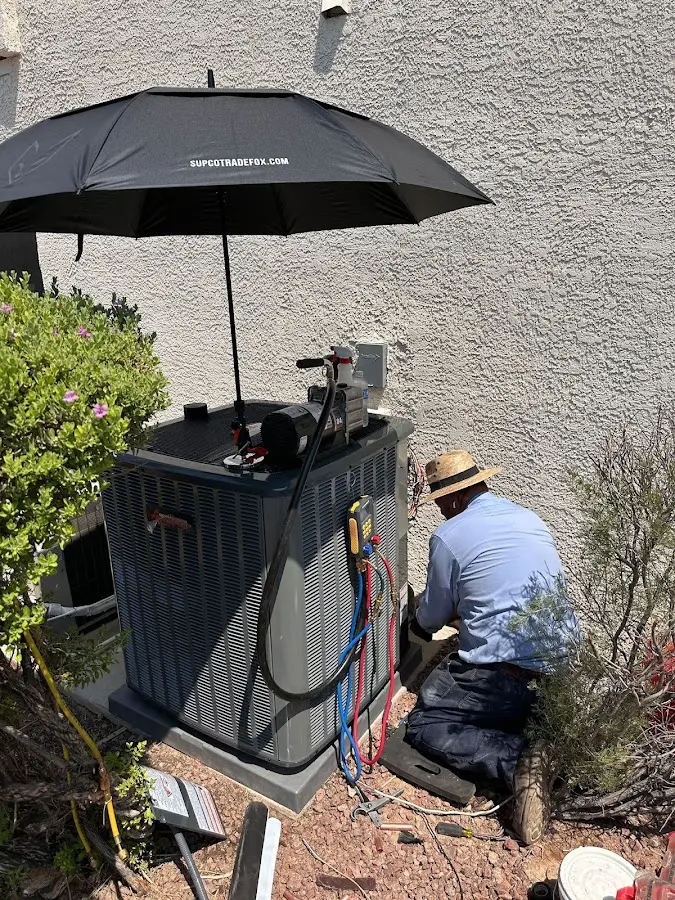 HVAC technician performing outdoor AC maintenance in Red Hook